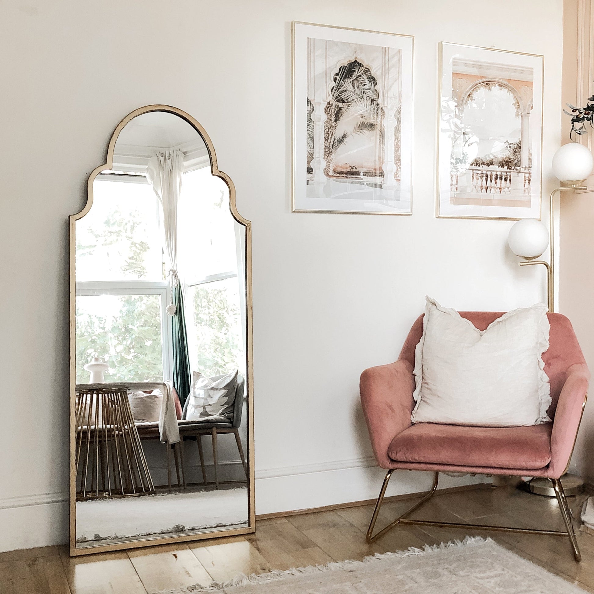 Dourado industrial arched full length metal mirror leaning against wall