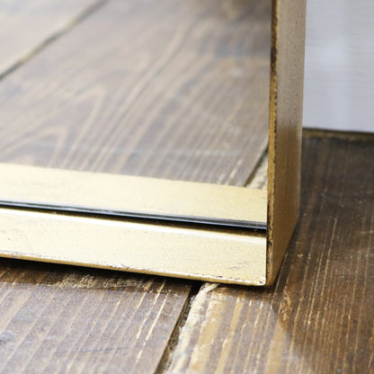 Closeup of Full length arched Dourado large metal mirror