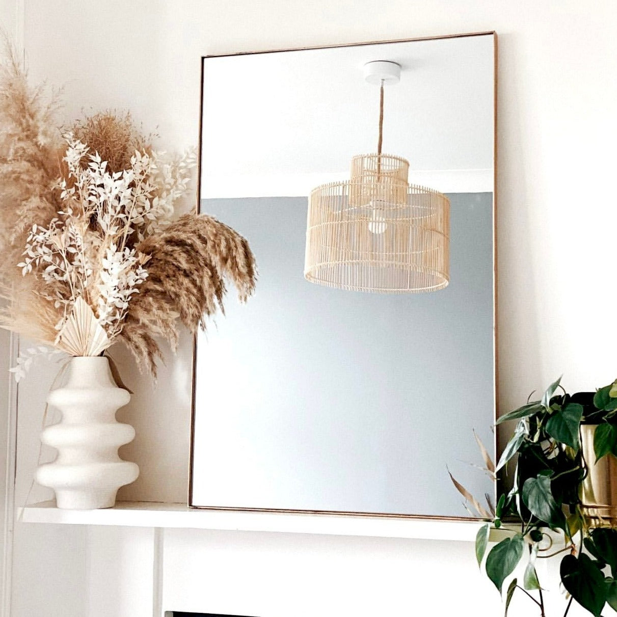 Dourado Rectangular Metal Wall Mirror reflecting chandelier
