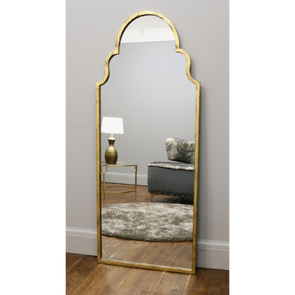 Dourado industrial arched large metal mirror leaning against wall